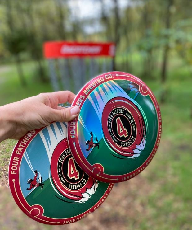 //fourfathersbrewing.ca/wp-content/uploads/2022/07/disc_golf_frisbees.jpg